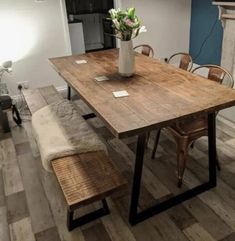 a wooden table and bench in a room