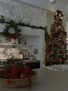 a kitchen decorated for christmas with a large tree in the center and other decorations on the counter