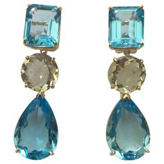 18kt Yellow Gold Geometric three stone drop Earring with Emerald Cut Blue Topaz, Round Green Amethyst and Pear shaped Blue Topaz Drop. The Earring measures 1 and 3/4" inches long and 1/2" wide at its most wide part. The Geometric earring can be made for Clip or Pierced earrings. This earring can also be made in White Gold with and combination of stones. Please contact me with any questions you may have at all. Green Amethyst Jewelry, Pink Jewellery, Purple Drop Earrings, Month Gemstones, Blue Topaz Jewelry, Sparkly Jewelry, Purple Jewelry, Blue Topaz Earrings, Earrings Purple