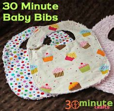 two bibs with cupcakes on them and the words 30 minute baby bibs