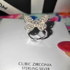 This Ring Is Super Lovely On Has Crystallized Czs. The Butterfly Sparkles Elegantly And Is Set On Platinum Plated Over Silver 925. A True Beauty. Orig Retail Price $135 White Gold Crystal Rings With Rhinestones, Gift Crystal Rings With Sparkling Stones, Silver Diamond Butterfly Ring, Silver Butterfly Ring With Diamond Accents, Luxury Crystal Ring With Sparkling Stones As Gift, Silver Butterfly Ring For Parties, White Gold Rings With Rhinestones As Gift, Diamond White Cubic Zirconia Butterfly Ring For Anniversary, Silver Ring With Rhinestones As Gift