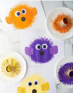 paper plates with different colored animal faces on them