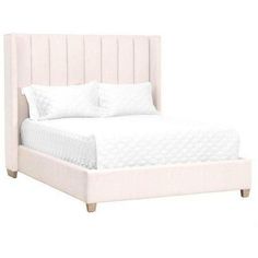 a white bed with two pillows on top of it and a night stand underneath the headboard