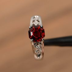 It is a natural garnet ring, octagon cut, measures 7mm*7mm, weight about 2.48 cts. The basic metal is sterling silver and plated with rhodium.To change the metal to a solid gold (white/rose) or platinum is also available, please ask for a quotation if you want.You can also go to my shop Home for more elegant rings: https://www.etsy.com/shop/godjewelry?ref=hdr_shop_menuGarnet is birthstone of January.More Garnet rings:https://www.etsy.com/shop/godjewelry?ref=seller-platform-mcnav&section_id=2 Elegant Asscher Cut Birthstone Ring, Red Asscher Cut Diamond Jewelry, Red Emerald Cut Birthstone Ring, Emerald Cut Red Birthstone Ring, Red Emerald-cut Sterling Silver Birthstone Ring, Octagon Ruby Ring As A Gift, Classic Red Radiant Cut Jewelry, Red Emerald Cut Diamond Jewelry, Classic Radiant Cut Red Jewelry