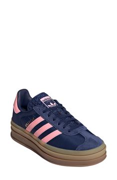 A triple-stacked platform elevates a time-tested sneaker, while serrated side stripes keep it close to its roots. Lace-up style Removable insole Leather upper/synthetic and textile lining/synthetic sole Imported Adidas Platform Sneakers Outfit, Spezial Adidas Shoes, Platform Gazelle, Blue Adidas Spezial, Adidas Bold, Pink Gazelles, Adidas Gazelle Bold, Gazelle Bold, Bold Shoes