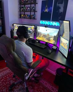 a man sitting at a desk with two computer monitors and a gaming controller in front of him