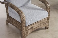 a wicker chair sitting on top of a cement floor