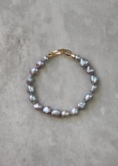 *Enjoy 10% off for a limited time. Use coupon code LIMITED10 at checkout. Does not include bespoke or custom changes. A chic, modern twist on your grandmother's classic pearls, the Rocco pearl bracelet is an elegant accessory featuring lustrous grey pearls, each exuding a contemporary sophistication while paying homage to timeless tradition. Perfect for any occasion, this bracelet effortlessly transitions from daytime grace to evening glamour. * DETAILS * > Designed and handmade in Australia > G Elegant Gray Bracelets As Gift, Elegant Gray Bracelet As Gift, Elegant Gray Bracelets For Gift, Elegant Gray Bracelet For Gift, Pearl Bra, Peachy Blush, Wedding Studs, Mother Of The Bride Gift, Beading Thread