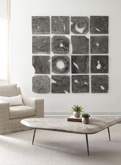 a living room with a coffee table and couches in front of a white wall