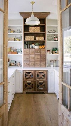 a kitchen with wooden cabinets and white walls