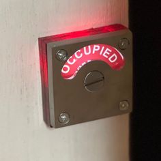 Model D-100 L.E.D. with Red Acrylic Mounting Bracket is the ultimate bathroom privacy indicator door lock with lighted occupied signage.  All of the electronics are housed on the back of the message disc including the battery.  It is surface-mounted to make installation on most doors easy.  The Red Acrylic Mounting Bracket glows red along with the OCCUPIED sign when the door is locked.  You'll be able to see if the room is occupied from any angle and distance up to 1000 feet. The photoluminescen Occupied Sign, Privacy Door, Toilet Sign, Battery Holder, Bathroom Doors, Sign Lighting, Bathroom Signs, Red Led, On Air