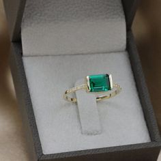 Handmade by an inspired jewelry artist team with decades of experience in the craft of jewelry making.Each gemstone, each diamond is carefully picked.Using only the finest raw materials and the highest industry standard in manufacturing, design and finish.A beautiful vintage inspired piece handmade just for you.Horizontally set Green radiant cut Emerald and Diamonds ring in a perfectly proportioned fine piece of jewelry.Beautifully finished this emerald ring will bring out the best in you and gi Emerald Ring Modern, Emerald Cut Moissanite Promise Ring, Moissanite Emerald Cut Ring For Gift, Emerald Jewelry With Radiant Cut Accent Stones, Fine Jewelry Emerald Cut Emerald Ring, Rectangular Emerald Gemstone Rings, Emerald Cut Emerald Ring In Fine Jewelry Style, Radiant Cut Emerald Jewelry With Accent Stones, Square Cut Emerald Diamond Ring For Anniversary