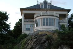 a large white house sitting on top of a hill