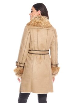 Delivering huge fashion impact with maximum warmth, our Dakota Fox coat SCORES! In luxe Latte vegan suede, the supple, soft hand ensures a fluid, compact silhouette. A luxurious Taupe Fox collar adds lush, plush warmth, along with the bonus of a strong shoulder. Continuing along the center front to the hem, this super-soft fur adds style AND verticality. With Chocolate tipping for authenticity, Taupe Fox is repeated in the adjustable cuffs. Inside a sheared fur lining provides welcome warmth while body-skimming princess seams front and back, provide a lean fit. Bold Chocolate whipstitching accents the flap pockets, sleeve belts, the boundless details and seaming! A tie belt, worn either front or back, pulls together this 37" coat that hints of effortless elegance and quiet confidence. Perf Elegant Suede Outerwear For Winter, Elegant Winter Suede Outerwear, Winter Faux Fur Belted Outerwear, Mink Leather Outerwear For Fall, Elegant Mink-colored Leather Outerwear, Fall Faux Fur Belted Outerwear, Beige Suede Outerwear For Fall, Fall Beige Suede Outerwear, Suede Long Coat For Fall