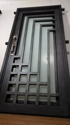 the door is made out of metal and has glass inserts on each paneling