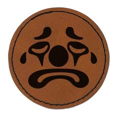 a brown floor mat with an angry face drawn on it