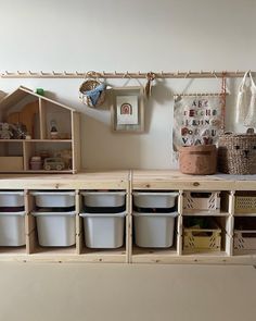 the shelves are filled with plastic containers and baskets for storing toys or other things,