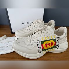 Gucci Men's Apollo Size Gucci 9+ (Us 10) Insole Length: Approximately 28 Cm New In Box, Guaranteed Authentic Made In Italy 100% Authentic White Rubber Sole Gucci Name In Shoe, Stars On Sole With Gucci Name Logo Gucci Printed Feature In Yellow And Green And Red On Side Of Shoe Lace-Up Closure Low Heel: 1.6" Height Gucci Leather Sneakers With Logo, Designer Beige Leather Sneakers, Gucci White Calf Leather Sneakers, White Gucci Sneakers In Calf Leather, White Gucci Calf Leather Sneakers, Gucci Low-top Cream Sneakers, Gucci Cream Low-top Sneakers, Luxury Gucci Beige Sneakers, Luxury Beige Gucci Sneakers