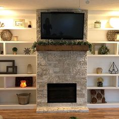 a living room filled with furniture and a flat screen tv mounted above a fire place