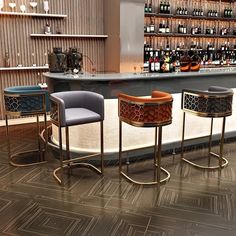 three bar stools sitting next to each other in front of a shelf with bottles on it