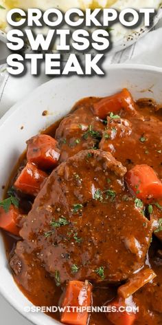 crockpot swiss steak with carrots and gravy in a white bowl