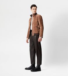 Synthesis of urban style and craftsmanship, this bomber jacket is crafted in soft suede, with ribbed knit collar and bottom hem. Fastened with branded buttons, it comes with two wide pockets with flap and two internal zipped pockets. Men Suede, East Hampton, Urban Style, Soft Suede, Knit Collar, Urban Fashion, Ribbed Knit, Bomber Jacket, Ready To Wear