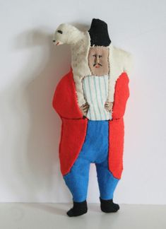 a stuffed animal with a man in a red jacket and blue pants holding a white goose