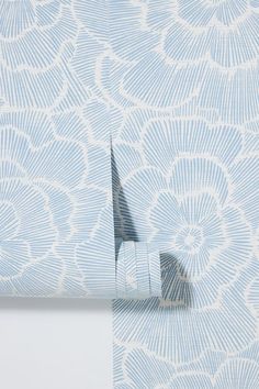 a blue and white wallpaper with an intricate design on it's side, including a clock tower