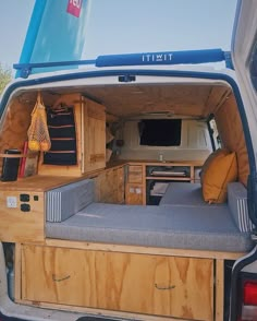 the back end of a van that has been converted into a camper with its bed up