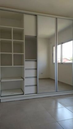 an empty room with sliding glass doors and shelves