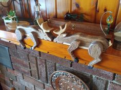 some deer heads are sitting on top of a fireplace