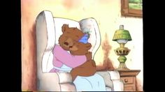 a brown teddy bear sitting on top of a white chair