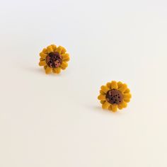 Cute sunflower stud earrings. All orders are packaged with care. Each box includes tissue paper, a tealight and a KelZo postcard. Product details: Polymer clay Approx 1cm Hypoallergenic surgical steel studs ****Colours may vary slightly from image due to resolution differences. Colour patterns may not match photographed item but will be cut from same piece/collection. Shapes and sizes may also vary due to the nature of handmade products.*** Care and Returns Please handle your KelZo Jewellery with care, as it is handmade and more fragile compared to mass market jewellery. Returns/replacements on pierced items are not accepted unless faulty, due to hygiene reasons. Please read our care guide and returns policy for more detailed information. Postage Please note, we aim to post all parcels wit Cute Sunflower, Mass Market, Tealight, Handmade Products, Tissue Paper, Color Patterns, Tea Lights, Sunflower, Polymer Clay