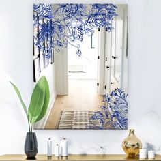 a blue and white painting hanging on the wall