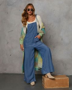 Meet the Nolah Relaxed Chambray Overall Jumpsuit—your go-to for effortlessly chic autumn style. Crafted from lightweight chambray fabric, this jumpsuit effortlessly blends Western ruggedness with Bohemian ease. Features include a practical front chest pocket and side slant pockets, plus adjustable shoulder ties for a perfect fit. Whether exploring fall foliage or lounging around, this jumpsuit offers a relaxed yet refined look that captures the essence of the season. Lightweight chambray fabric Jumpsuit Fall, Western Wear Dresses, Chic Autumn, Overall Jumpsuit, Chambray Fabric, Swimwear Bottoms, Autumn Style, Dresses By Length, Wrap Sweater