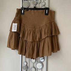 Taupe Rayon Ruffle Skort Fitted Mini Skirt With Ruffles, Chic Brown Ruffled Bottoms, Brown Skirted Bottoms With Ruffled Skirt, Brown Ruffled Skirted Bottoms, Brown Skirted Bottoms With Ruffled Detail, Brown Ruffled Skirt Bottoms, Stretch Ruffled Short Skort, Short Stretch Skort With Ruffles, Stretch Ruffle Skort