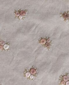 the fabric has pink flowers and pearls on it