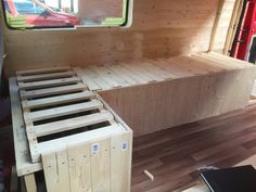 a bed made out of wooden pallets in the back of a truck or van