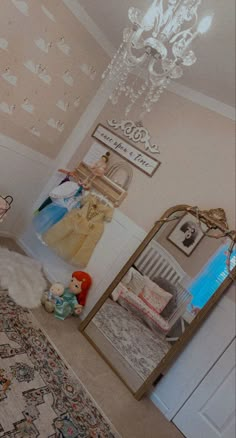 a bedroom with a chandelier, mirror and rug on the floor in front of it