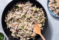 a skillet filled with pasta and mushrooms