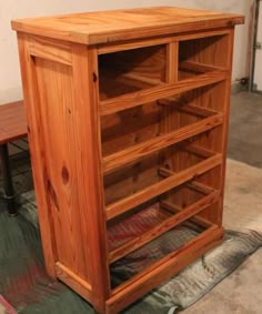 a wooden book shelf sitting on top of a rug