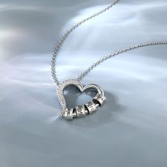 This sterling silver necklace's pendant, a hollow out heart clasp design, delicately crafted from pure silver. It's a beautiful symbol of love, friendship, and family. The hollow out heart clasp pendant allows you to customize the necklace by adding rings inscribed with the names of your loved ones. Each circle is a reminder of the special bond you share with each family member, a tangible expression of your love and appreciation. As you wear the heart necklace with your family name customized, Sterling Silver Open Heart Necklace With Heart Beads, Silver Double Heart Jewelry With Chain, Silver Open Heart Necklace With Heart Beads, Silver Open Heart Necklaces With Heart Beads, Silver Heart Necklace With Round Pendant For Anniversary, Sterling Silver Round Pendant Necklace For Anniversary, Silver Heart Pendant Necklace With Heart Beads, Fine Jewelry Silver Necklace With Heart Charm, Silver Heart Bead Pendant Necklace