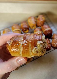 a person holding a pastry in their hand