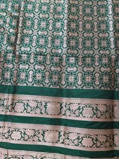 This Banarasi handloom pure silk lehenga is a perfect festive/wedding/occasional wear it enhanced with green color motifs.  Occasion: party wear/wedding  Materials. Pure silk. Unstich  Fabric design - Banarasi  lehenga  Pattern: paisley/buti motifs.  Borders: yes  Border type: Zari  Zari type: golden zari. Fabric length with blouse and with dupatta.  Borders is 6.5 meters  Blouse: 0.85 Meters  No of kali: 18 Size of kali 42 inch  No of border in dupatta 9 Traditional Green Raw Silk Sharara, Green Raw Silk Anarkali Set For Festivals, Festival Green Raw Silk Anarkali Set, Festive Green Tussar Silk Sharara, Green Traditional Unstitched Suit For Festivals, Green Banarasi Silk Sharara For Wedding, Green Unstitched Suit For Traditional Ceremonies And Festivals, Green Tussar Silk Sets With Traditional Patterns, Green Unstitched Zari Weaving Sharara