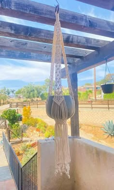 a hammock hanging from the side of a building in front of a cactus