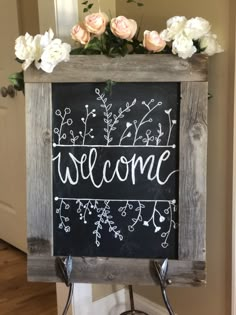 a welcome sign with flowers on it