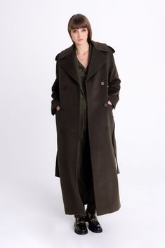 Crafted from premium-quality wool, this double-breasted forest green coat offers a fitted and feminine silhouette with superior warmth. This coat showcases a sleek, straight silhouette adorned with spread shoulders and peak lapels. Its design includes front pockets and a waist belt, along with embellished belt accents on the shoulders. Material: 98% Wool, 2% Polyamide Lining: 55% Polyester, 45% Viscose  Wash is not allowed/Do not bleach/Do not tumble dry/Cool iron/Dry clean only Forest Green Coat, Embellished Belt, Brand Magazine, Stocking Fillers For Her, Forever Jewelry, Green Coat, Feminine Silhouette, Jewelry Ring Box, Mens Jewelry Bracelet