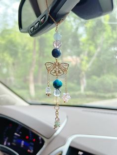 the interior of a car with beads hanging from it's dashboard