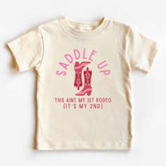 a toddler's t - shirt with the words saddle up on it