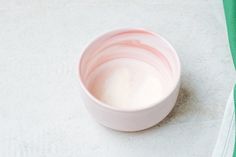 a pink bowl sitting on top of a white counter